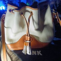 This vintage Dooney & Bourke white and bown draw string purse