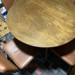 Round Dining Room Table And Four Synthetic Leather Chairs