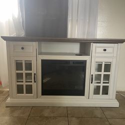 Entertainment center with a fireplace