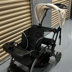 Baby Trend Double Infant and Toddler Stroller w/ Harness and Basket, Sit N' Stand, Khaki