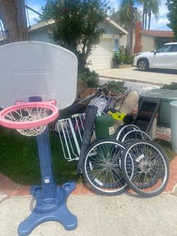 FREE - Two camping cots, bike rims, old broken REI tent, kids basketball hoop, kids scooter, blower no battery, rug, lobster nets
