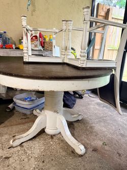 Round farmhouse table with three chairs