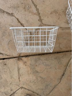 Four metal storage baskets