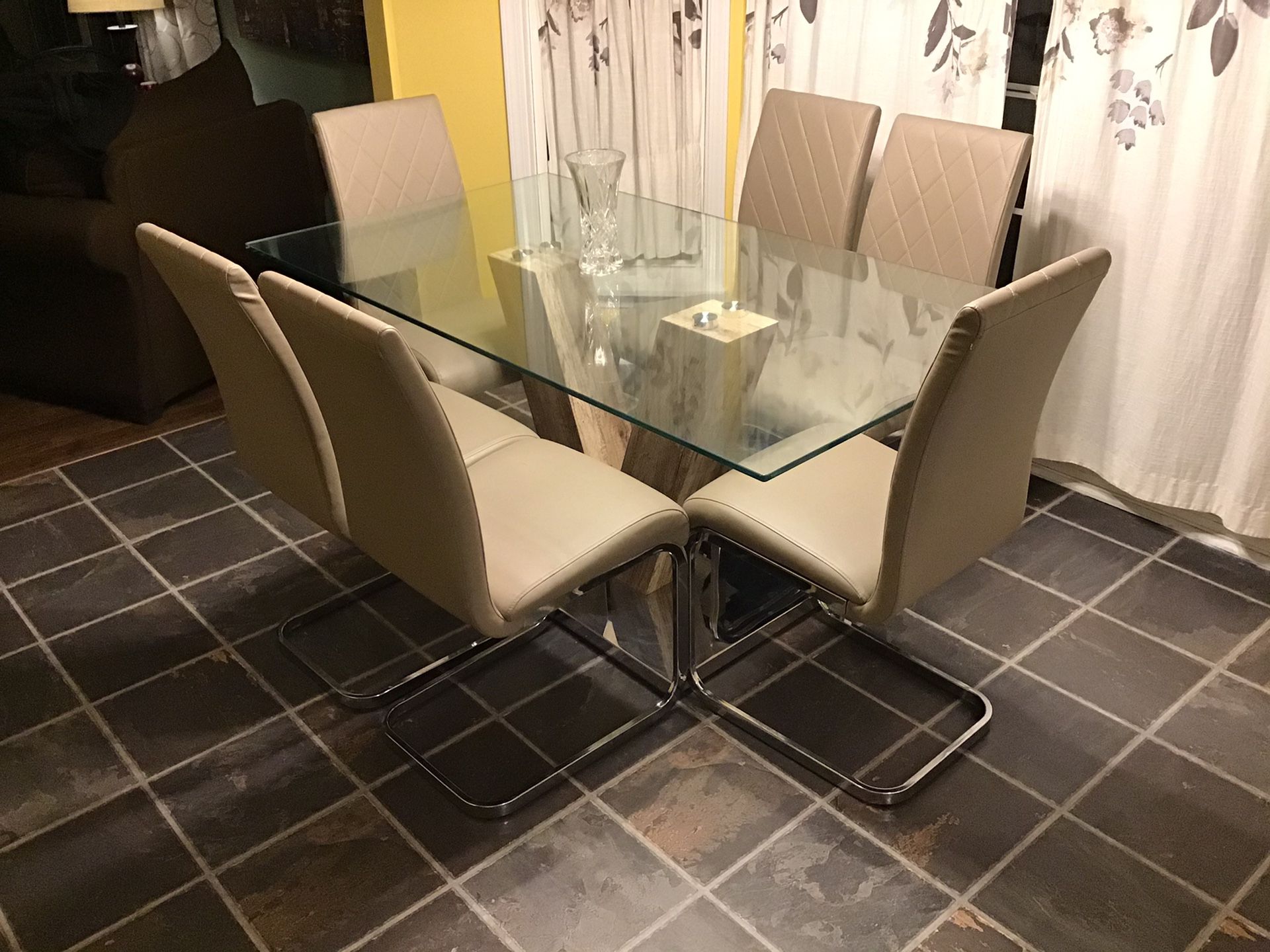 Glass kitchen table with 6 lather chairs, very good quality.