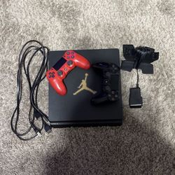 ps4 slim with 2 controllers and a controller charger