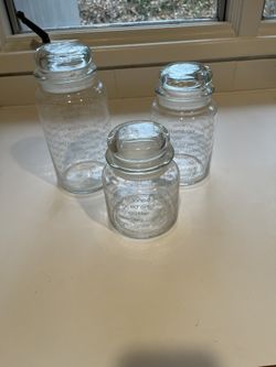 Three Glass Jars With Glass Tops 