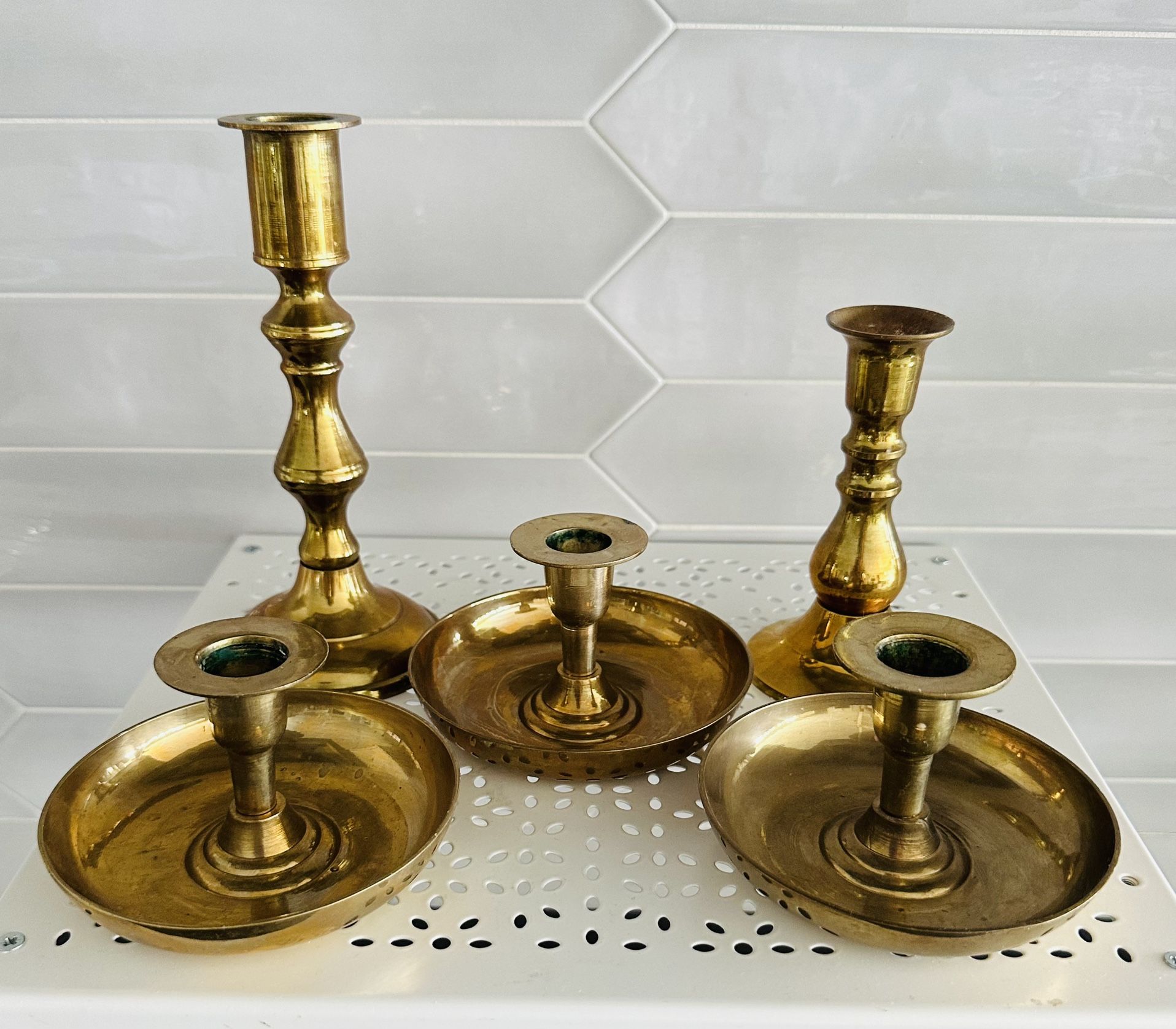 Set of 5 vintage Korea brass candle Stick holders 7 1/4” tall x 3 1/4” across bottom , 5” tall x 3” across bottom, 3 are approx 2 3/4” tall x 4 1/2”