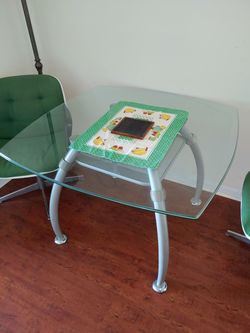 Glass and metal dinner table