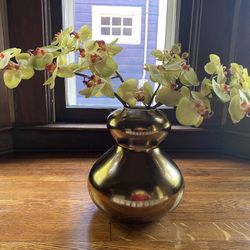 Gold over ceramic vase with flowers