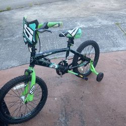 shows an 18-inch Surge Boys Bike in green and black