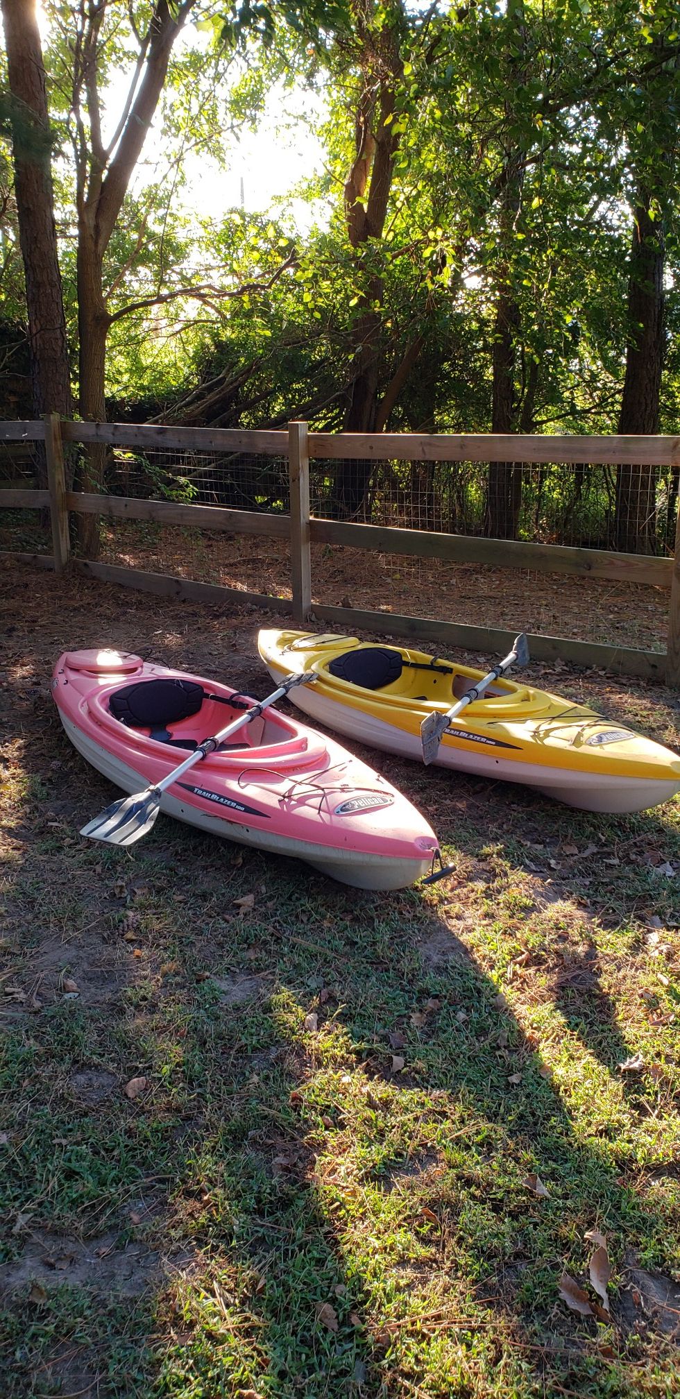 2 kayaks with paddles and life jackets