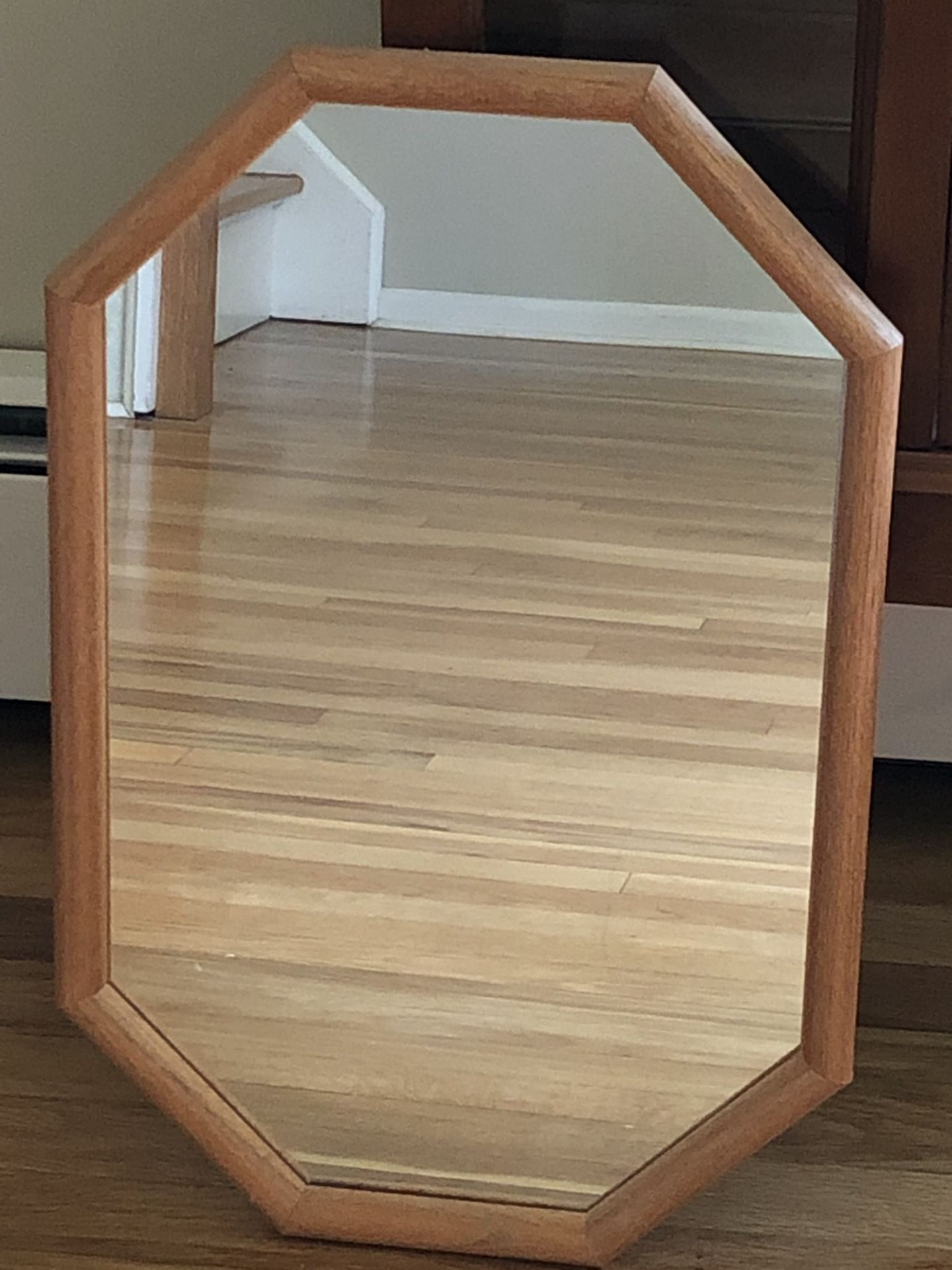 Octagonal wooden framed mirror.