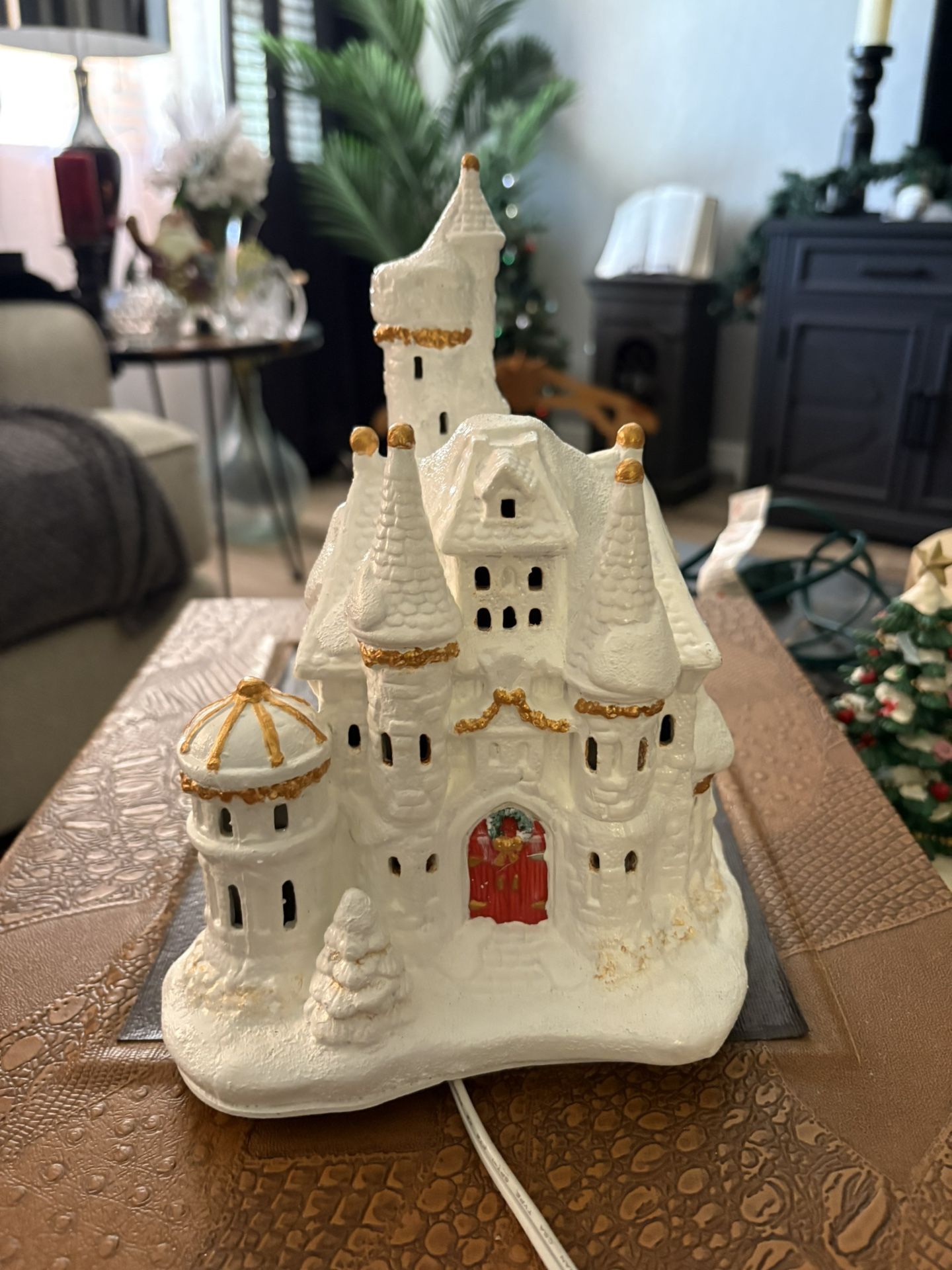 Walt Disney Princess Belle's Castle Snow Village" collectible, likely produced by Brass Key Keepsakes.  This is a lighted castle figurine, designed as