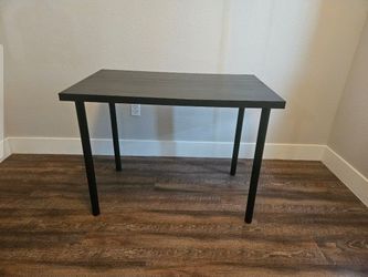 IKEA LINNMON tabletop with ADILS legs, forming a desk or table unit.
