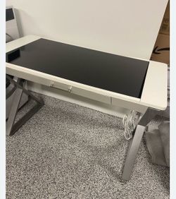 Used - good condition desk with USB, power outlets, and partial glass top