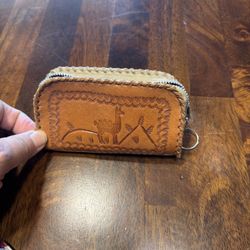 Peru leather coin purse with a stitched design featuring a llama and mountains