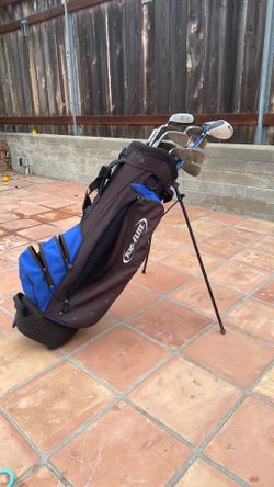 Golf clubs and bag with balls and tees
