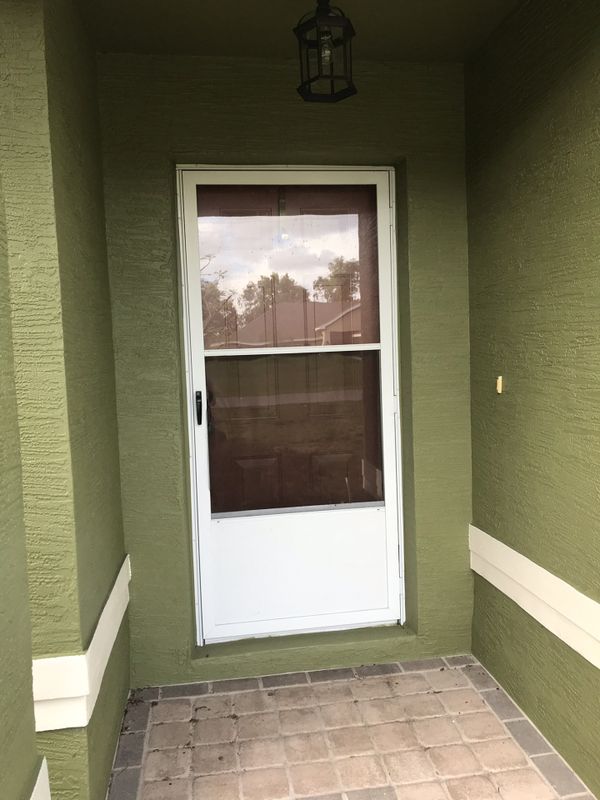 Storm door/ screen door with glass window for Sale in Spring Hill, FL