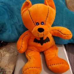 BEAR brand Good Stuff, featuring a unique design with a bat on its chest. The bear is orange in coplor 