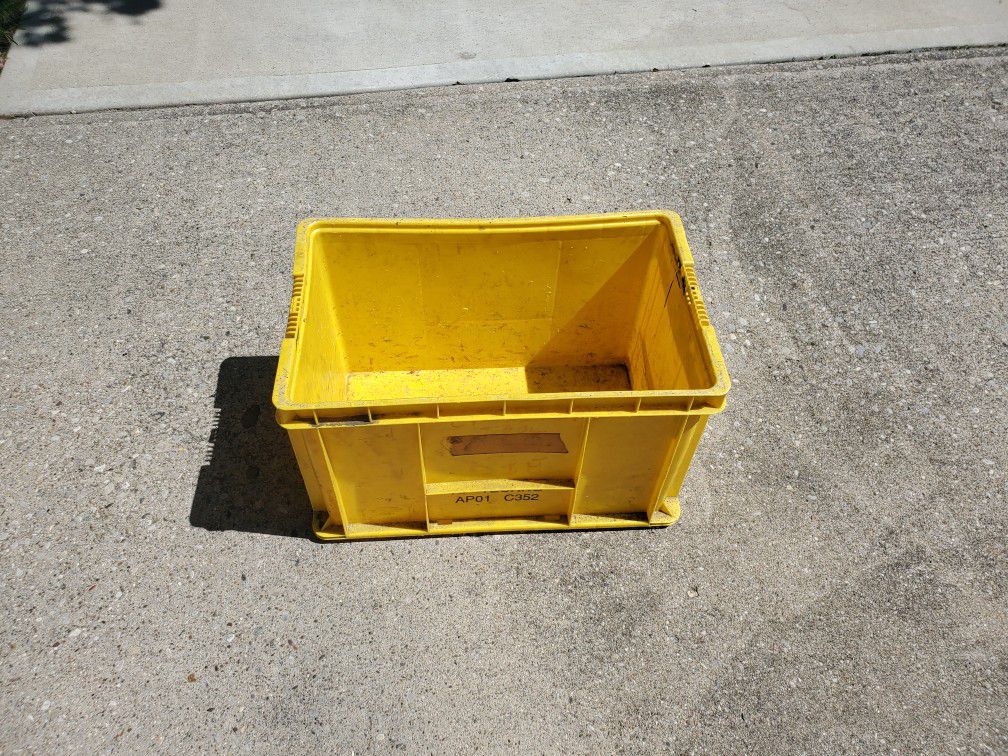 A Hard plastic storage container with handles 21 inches long x14 inches wide and 14 inches deep