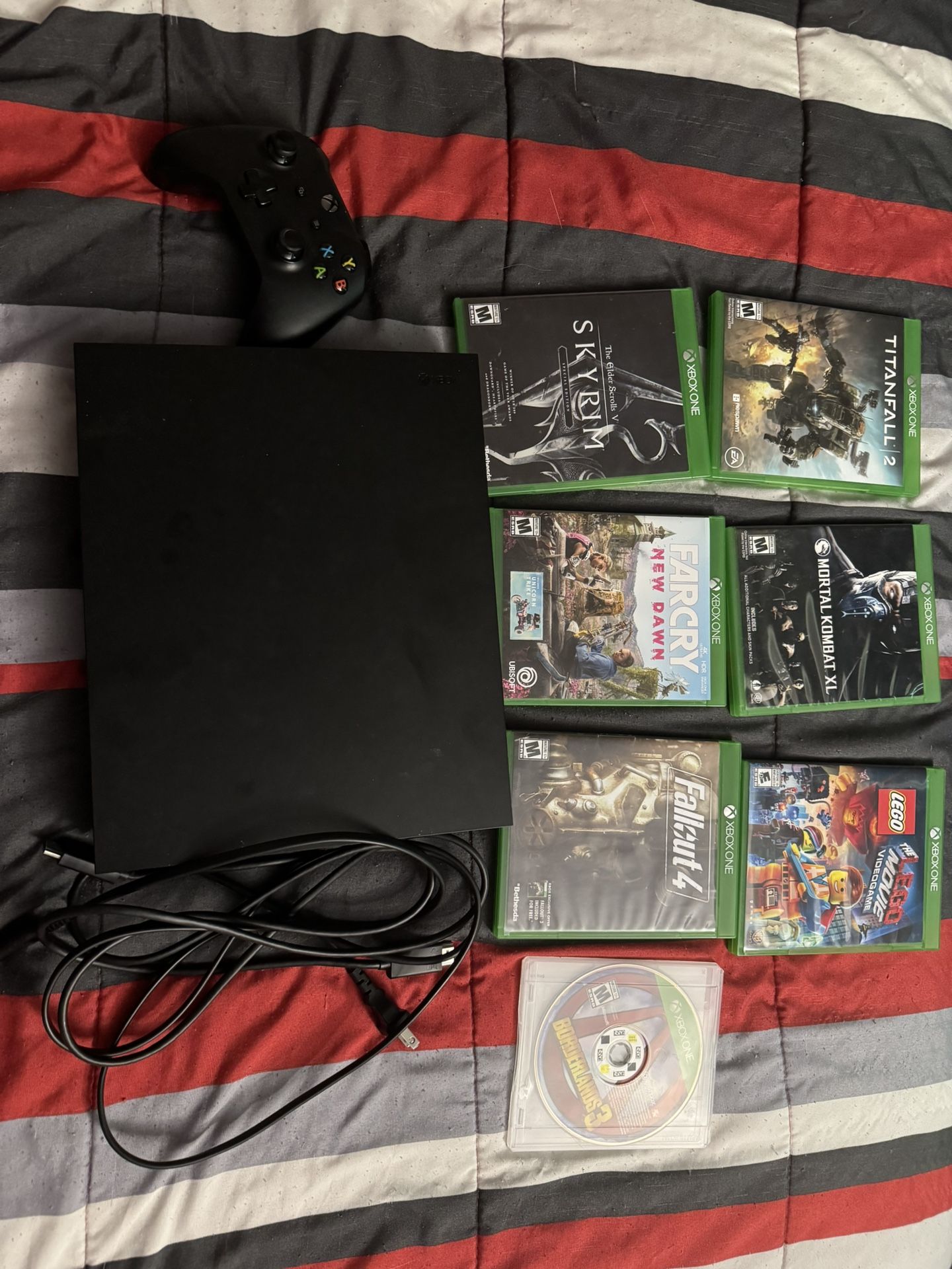 XBOX ONE X W/ controller , power cords and 7 Games !