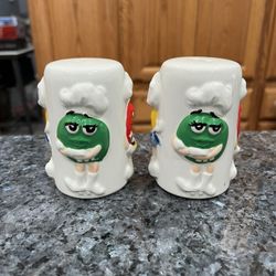 Ceramic White M&Ms with Red, Green and yellow Pair of Salt and Pepper Shakers.  Size approximately 3  1/2 inches tall.  Brand new never used.  