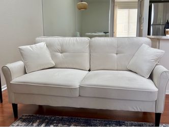 Cream color sofa with matching pillows