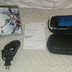 Sony PSP Console w/ x2 cases, charging chords, instructions, and x3 games