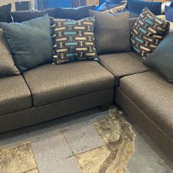 Black, gray, silver and teal sectional