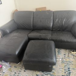 Black leather couch with storable ottoman