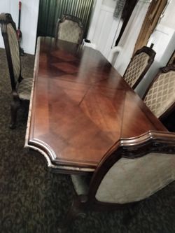 Beautiful dining room dinner table with eight chairs and matching hutch