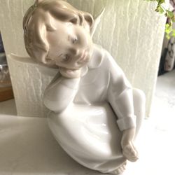 LLADRO Spain- Angel Dreaming Figurine. Porcelain angel figurine sitting with his head resting on his hand  No chips or cracks  / does not come with bo