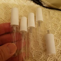 This listing is for 5 refillable empty glass perfume spray bottles with white atomizer 

5 ML. Glass refillable bottles 

Please go to my page and see