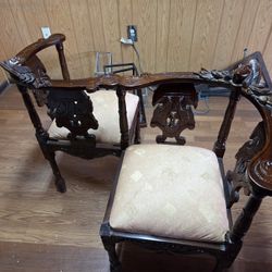 This is a Victorian-style carved wood tête-à-tête