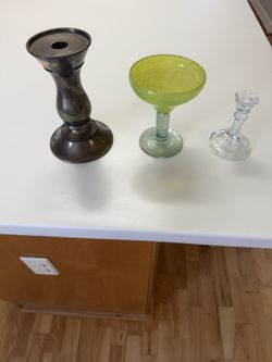 3 Candle Holders. 1 Bronze 10 Inch Tall, 1 Green Glass 7 Inch Tall, 1 Clear Solid Glass 6 Inch Tall