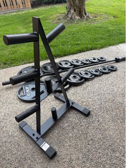 Olympic weights with barbell and storage tree 2x45, 2x35, 2x25, 2x10, 4x5 and 3x2.5 lbs
