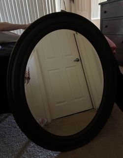 Oval framed black mirror