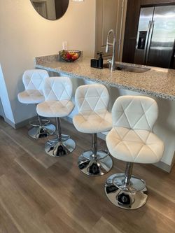 Four White Matching Swivel Barstools