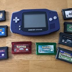 Game Boy Advance (Indigo): The original AGB-001 model in its signature translucent purple (Indigo) color. It features the wide ergonomic design, a gre