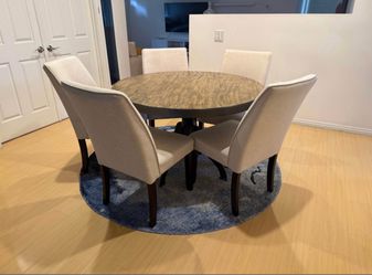 Round Wood Dining Table with 5 Upholstered Chairs.