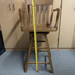 Tall wooden swivel chair