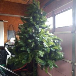 ARTIFICIAL FRASER FIR TREE FOR SALE. 7 FOOT TALL. 150 DOLLARS. LOOKS REAL