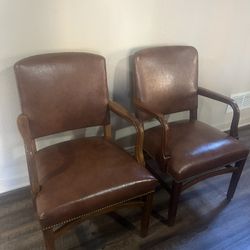 Two light brown leather chairs