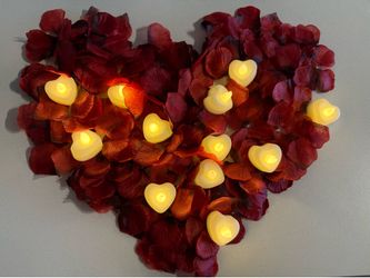 12 heart-shaped LED tea candles and faux rose petals