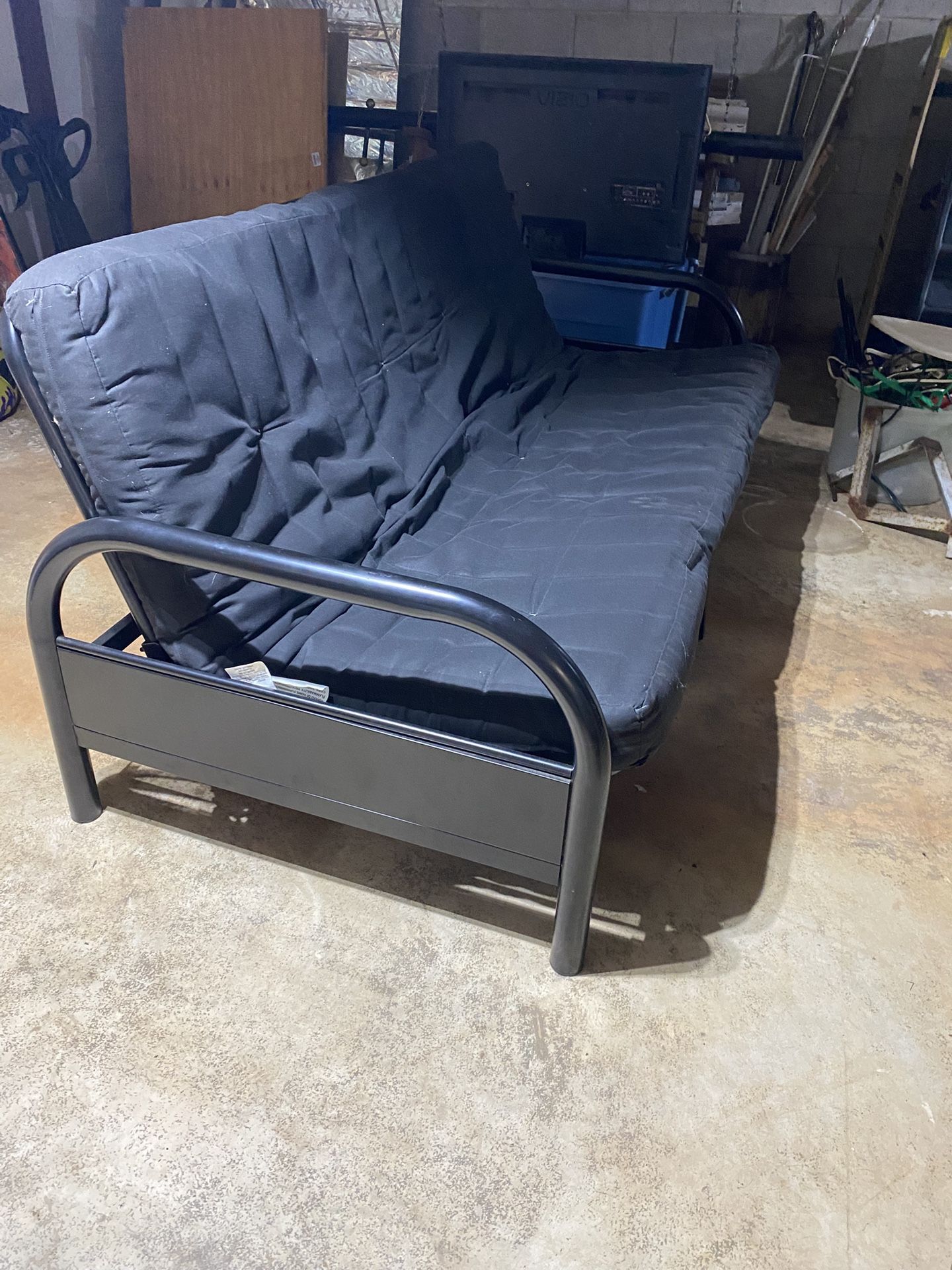 Black Futon Lays Down For Bed