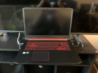 Acer Nitro 5 gaming laptop featuring an Intel Core i5-9300H processor, 8GB of RAM, and a distinctive red-backlit keyboard.