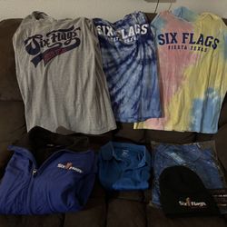 A Six Flags Jacket (big XS)- All Like new-2 Employee Shirts-M- 1 Black Beanie  — 3 Six Flags Tops M) & 1 Pair of Pink (Over Bikini Bottom) Pants  —- 