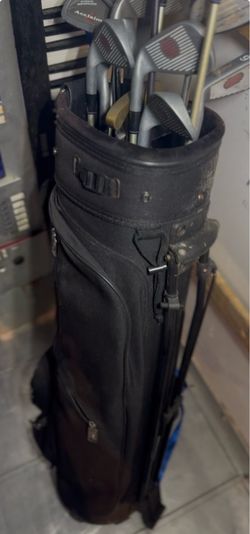 Assorted golf clubs and carry