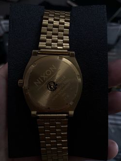 Stainless steel Nixon gold watch