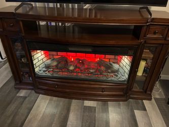 oak wood television stand and fireplace
